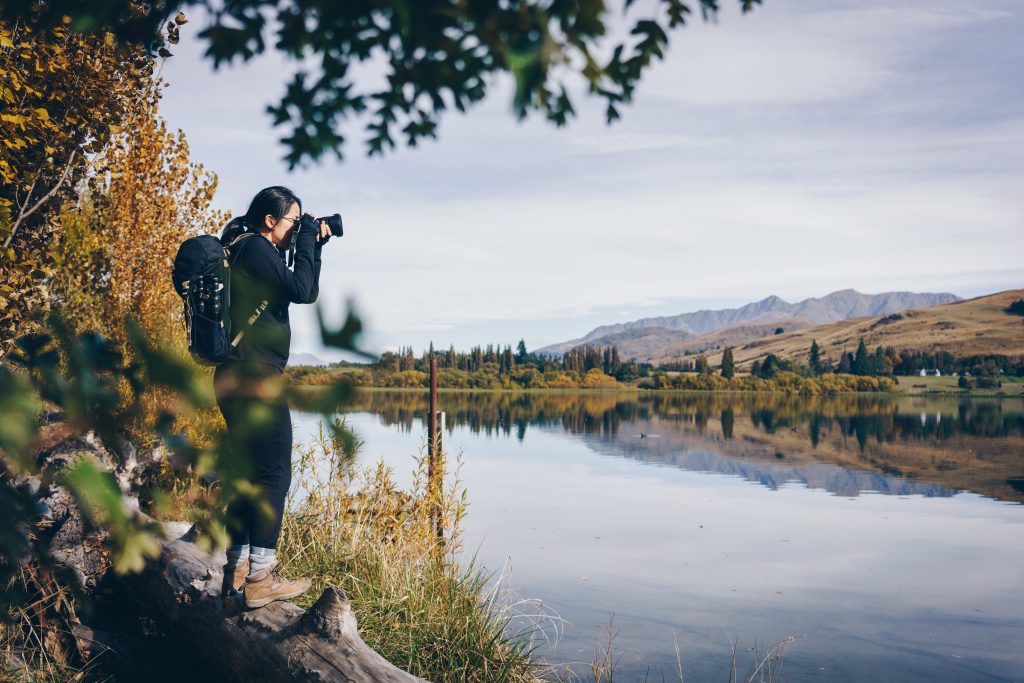 woman taking a photo in the country