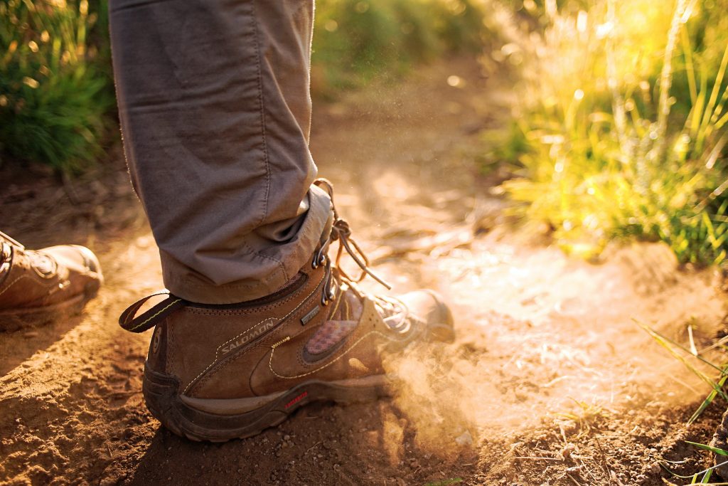 sythetic walking boots on dusty ground