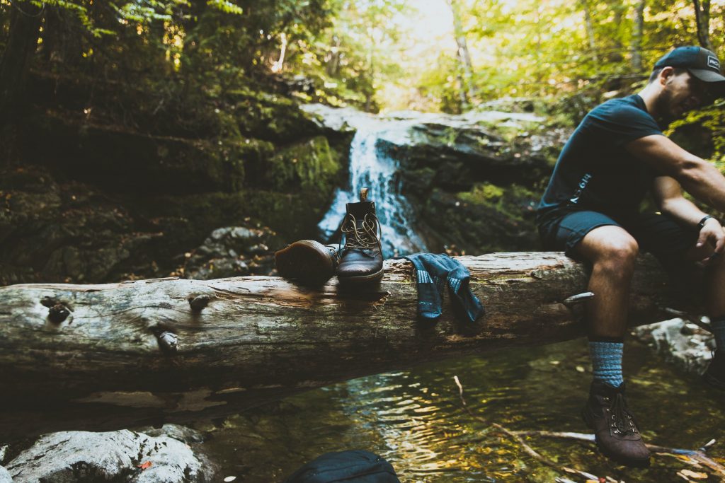 walking boots and socks on a log