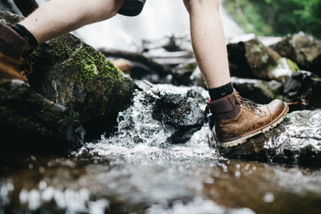 leather walking boots in a river